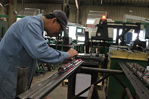 Man working on a perforating gun at Hunt & Hunt's facility